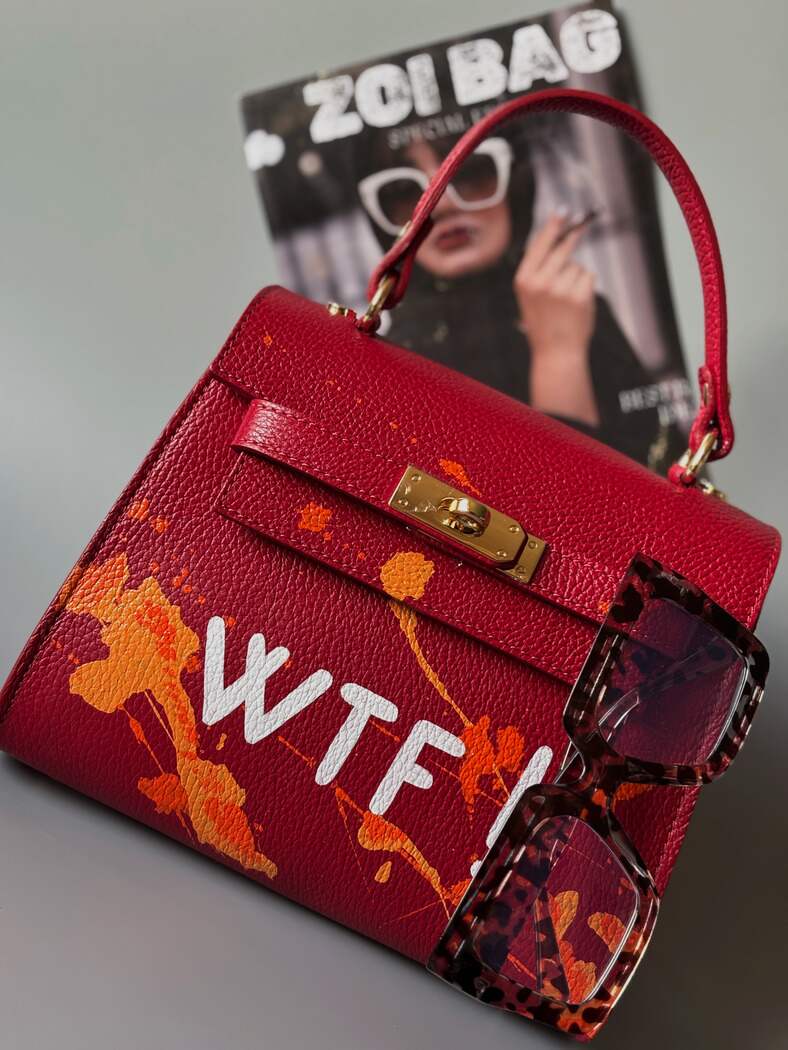 Designová červená crossbody kabelka Zoi Bag z pravé italské kůže s ručně psaným nápisem a cákanci barvou.