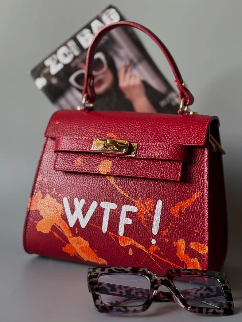 Designová červená crossbody kabelka Zoi Bag z pravé italské kůže s ručně psaným nápisem a cákanci barvou.