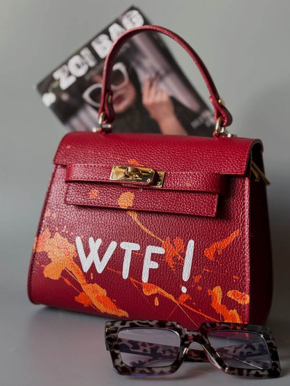 Designová červená crossbody kabelka Zoi Bag z pravé italské kůže s ručně psaným nápisem a cákanci barvou.