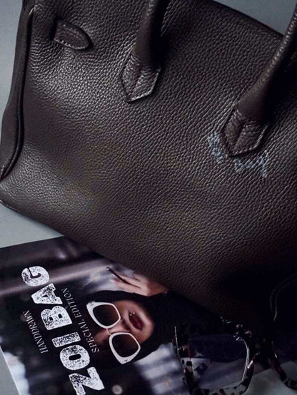 Designová hnědá kožená kabelka Zoi Bag s nápisem "On a Mission"  zezadu