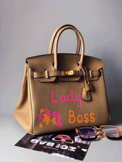 Art kožená béžová kabelka Zoi Bag s nápisem "Lady Boss" z boku