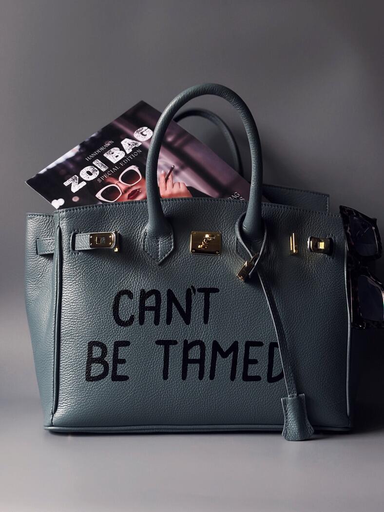 Kožená velká šedomodrá kabelka Zoi Bag s ručně psaným nápisem "Can't be tamed"