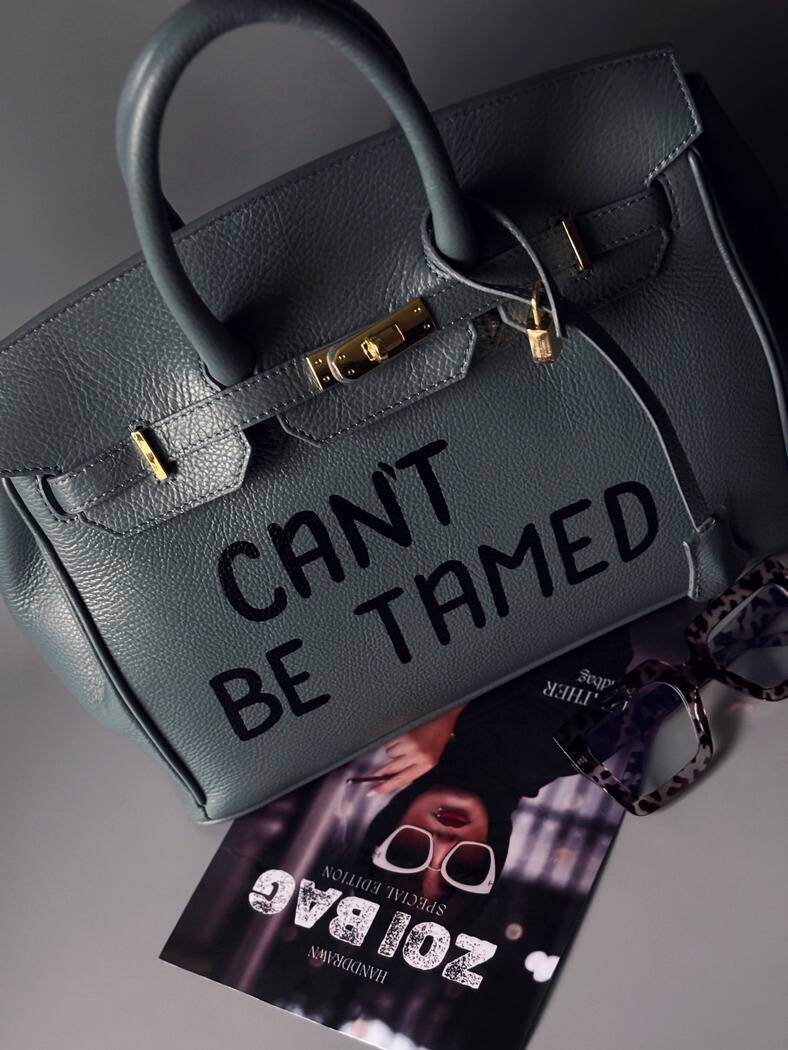 Kožená velká šedomodrá kabelka Zoi Bag s ručně psaným nápisem "Can't be tamed"