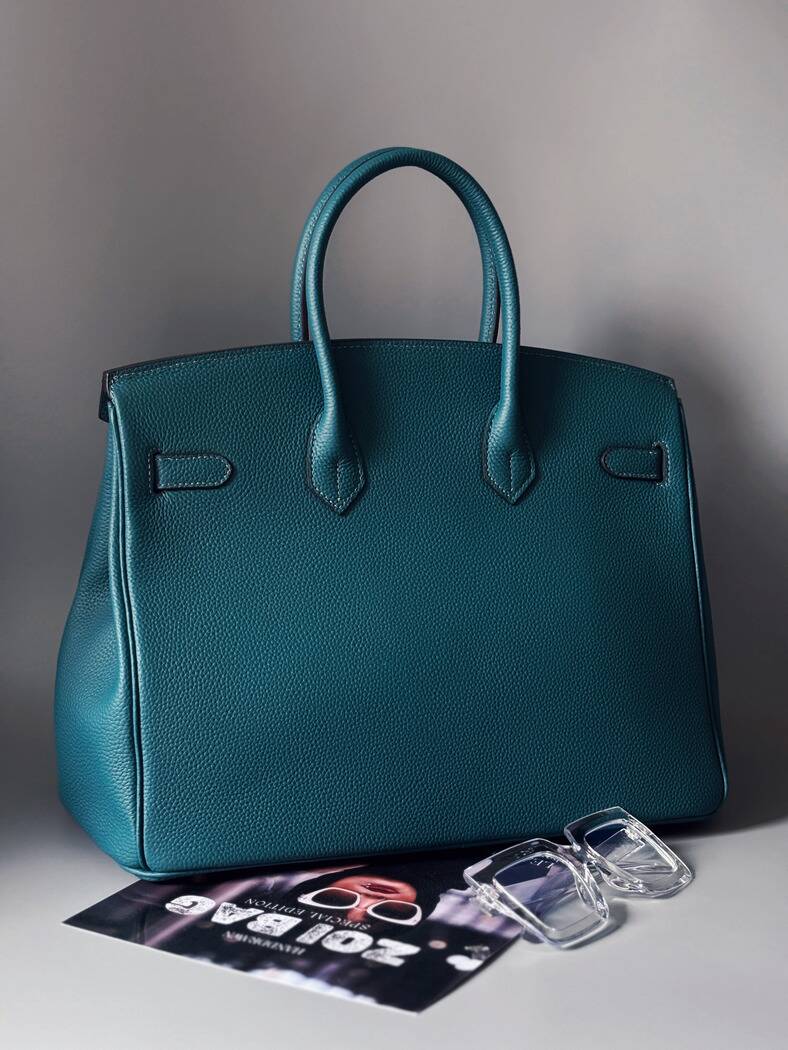 Originální modrá kožená kabelka Zoi Bag s nápisem "On a Mission" zezadu