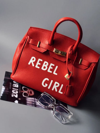 Oranžová kožená kabelka Zoi Bag s nápisem "Rebel Girl"